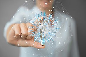 Businesswoman,On,Blurred,Background,Holding,A,Lighbulb,With,Connections,In