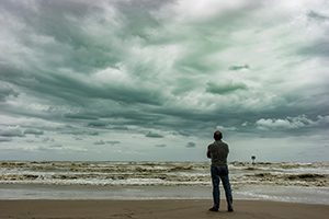 A,Person,Looking,At,The,Horizon,During,A,Stormy,Day